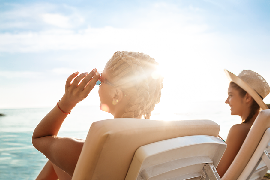 Two women sunbathing on the beach