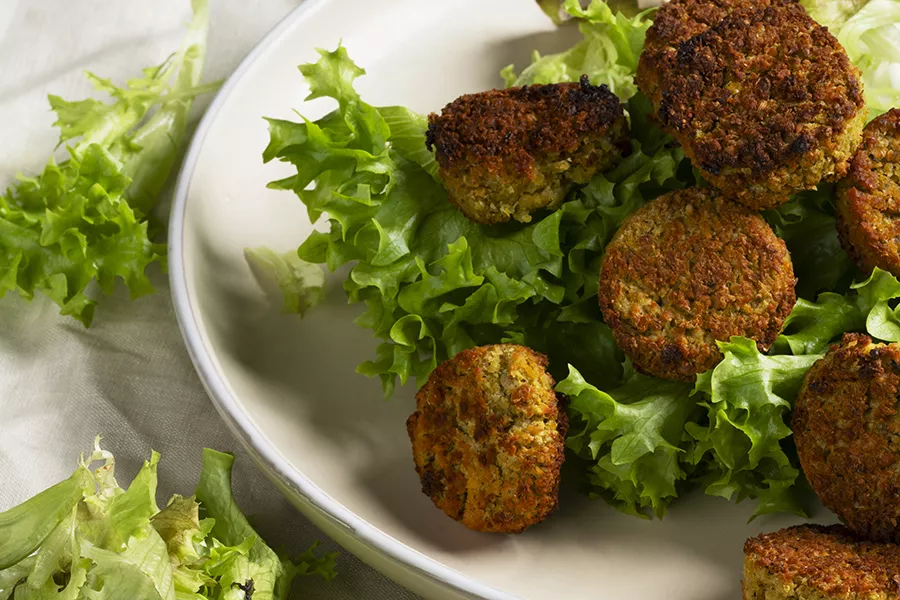 A plate with lettuce and quinoa meatballs