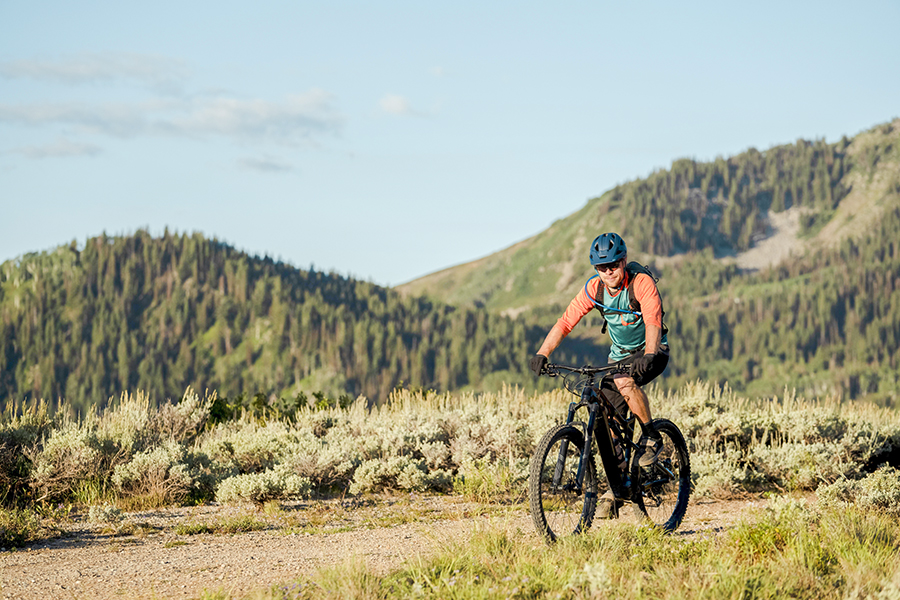 A man riding a mountain bike on a dirt road.